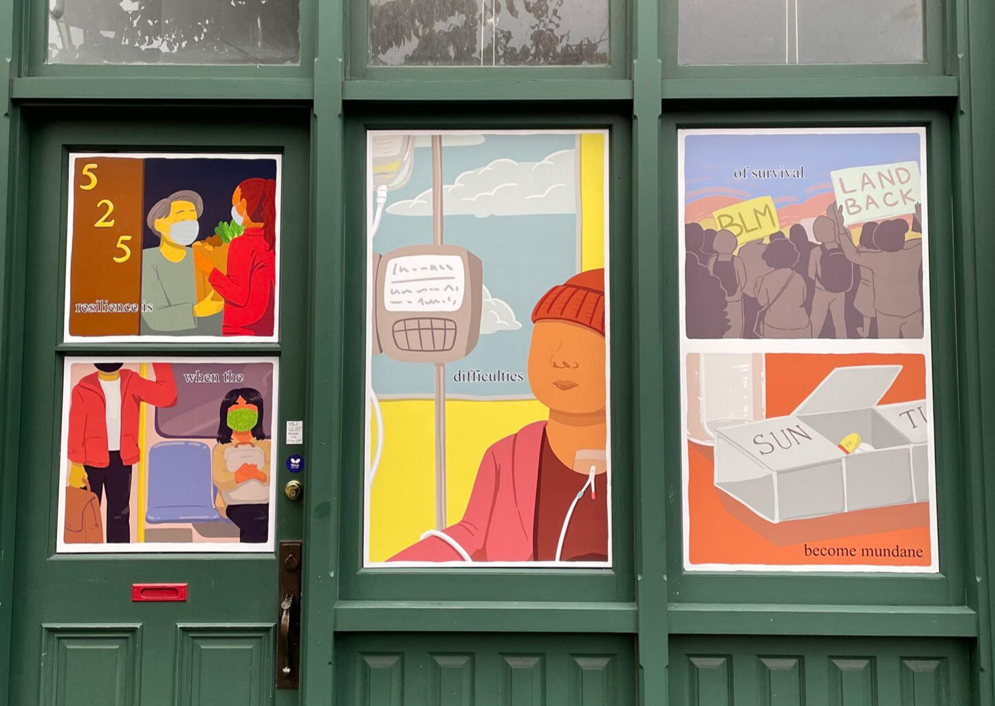 Photo of a comic on the door and windows of a green building. The text reads "resilience is when the difficulties if survival become mundane". the images show a person delivering groceries to a senior, people masking on public transit, someone receiving ch