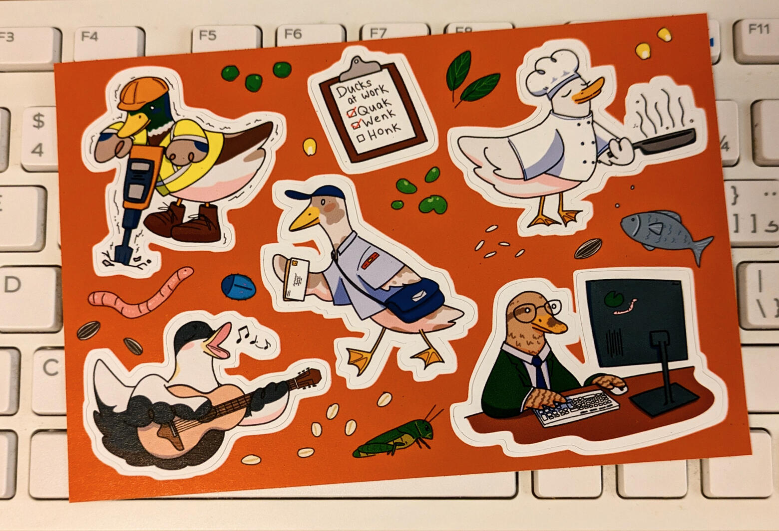 Sticker sheet with ducks working! From left to right: jack hammer duck, mail duck, duck chef, busking duck, and office worker duck.